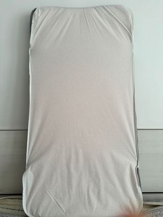 Cuna de bebé blanca con patas de madera