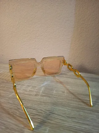 Conjunto Bolso impermeable y gafas doradas