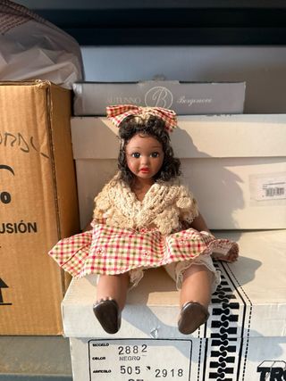 Muñeca sentada con vestido de cuadros