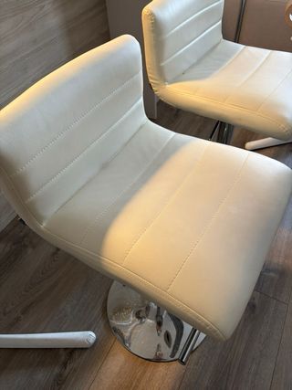 Taburetes altos blancos y plateados