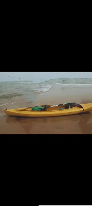 Kayak rígido amarillo con carro de transporte
