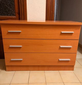 Cómoda de madera marrón, tiene una esquina mal