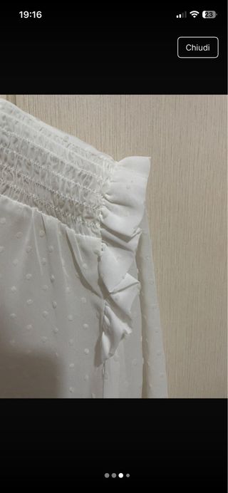 Blusa bianca trasparente con pois