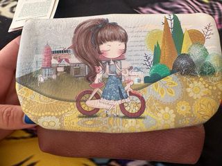 Monedero con dibujo de niña y bicicleta