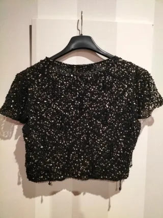 Chaquetilla fiesta lentejuelas negra y dorada.