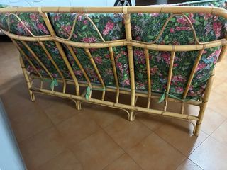 Sofá de bambú con cojines florales