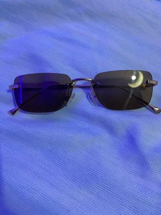 Gafas de sol sin montura doradas y negras