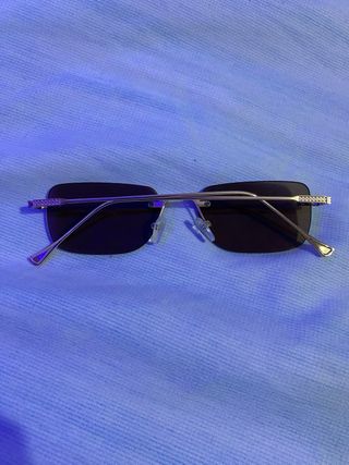 Gafas de sol sin montura doradas y negras