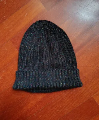 Cappello nero luminoso e guanti grigi