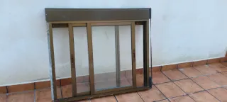 Ventana corredera de aluminio marrón, con persiana
