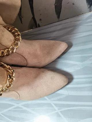 Botas altas beige con cadena dorada