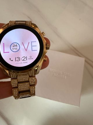 Reloj Michael Kors Dorado y plateado con celular.