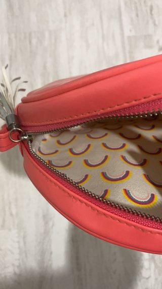 Bolso redondo coral con pompón plateado