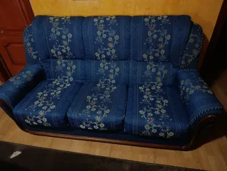 Sofá de tela azul con detalles florales