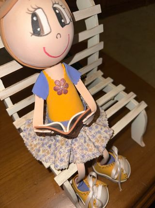 Muñeca artesanal sentada leyendo