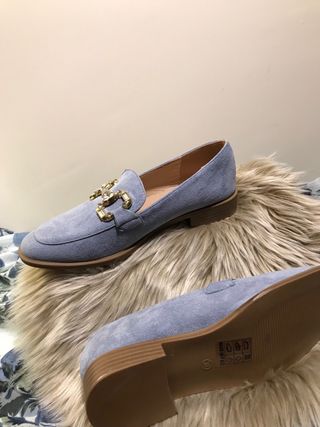 Zapatos planos azules con detalle dorado