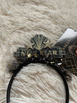 Cerchietto nero e oro con scritta “New Year”