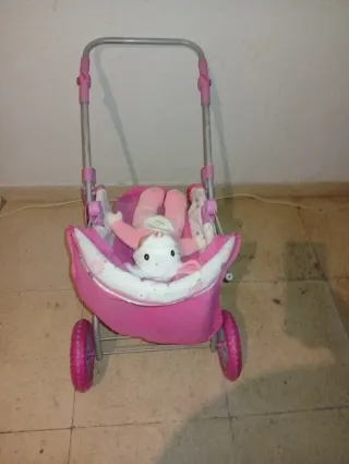 Muñeca con carrito rosa