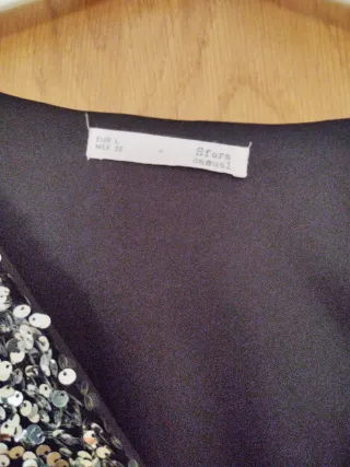 Jersey pico lentejuelas negro y plata.