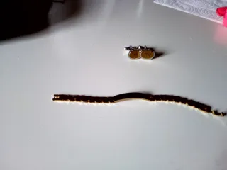 Esclava y gemelos dorados y plateados