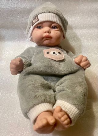 Muñeco bebé tipo reborn pololo gris, muy realista