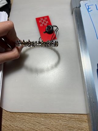 Pulsera Carolina Herrera estrellas oro y plata