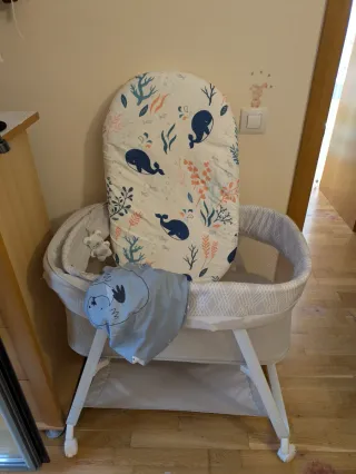 Cuna de viaje con ruedas, colchón y varias fundas.