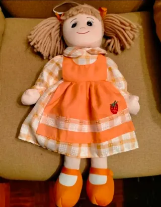 Muñeca de trapo con vestido naranja y fresa