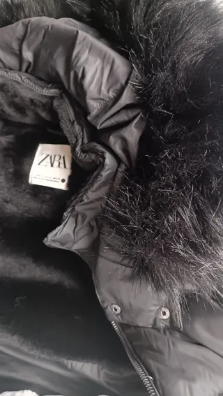 Plumífero negro con capucha y cinturón