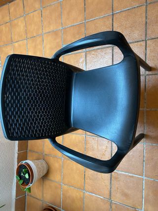 Silla de terraza negra con cojín blanco