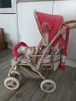Carrito gemelar de juguete rosa