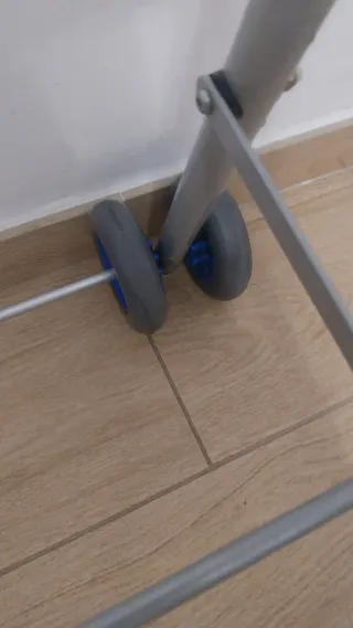 Andador con ruedas y asas azules ,de aluminio .