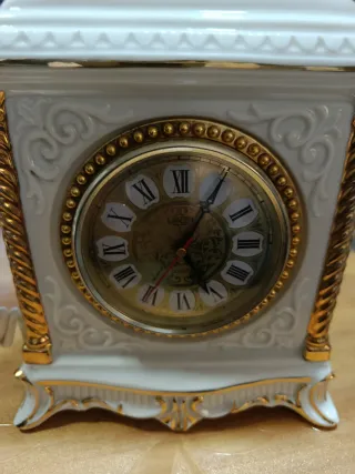 Reloj antiguo teléfono blanco y dorado