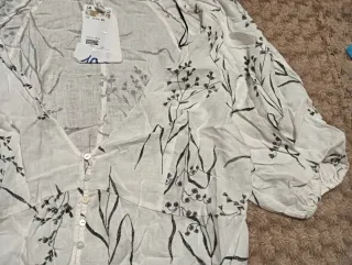 Blusa blanca con estampado floral negro