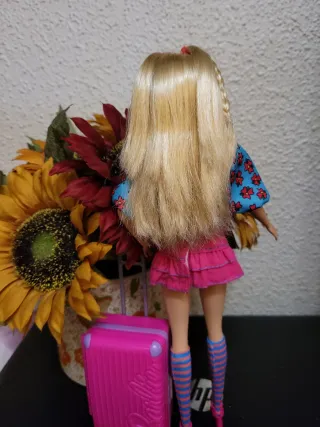 Muñeca Barbie con maleta y flores