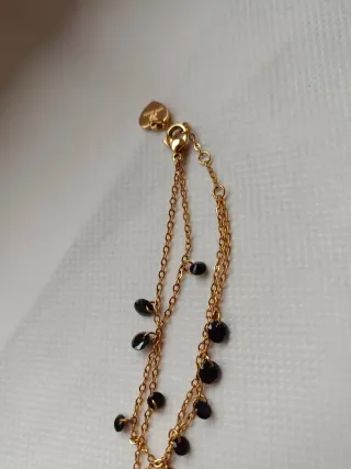 Braccialetto con pendenti neri e oro