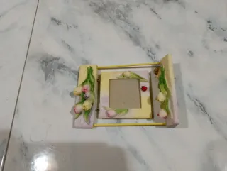 Portafoto altalena con coccinella