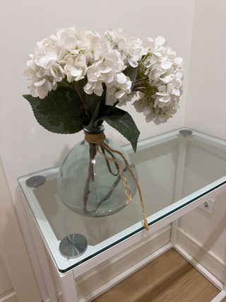 Jarrón de cristal con flores blancas