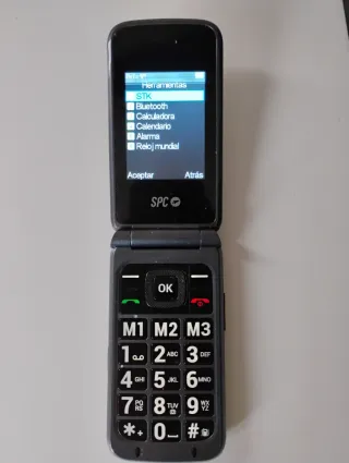 Teléfono móvil SPC con base y cargador