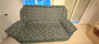 Sofá de tela verde con estampado floral