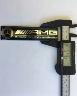 EMBLEMA AMG NEGRO SILICONA MERCEDES LOGO INTERIOR