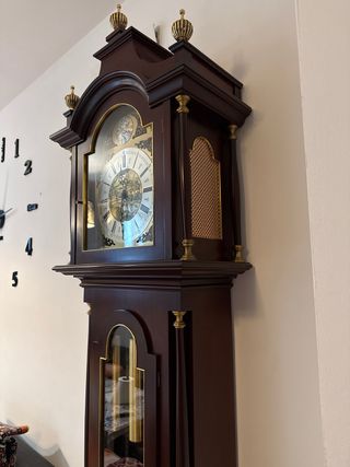 Reloj de pie clásico antiguo con péndulo y pesas.