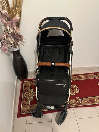 Carro de paseo plegable negro y dorado