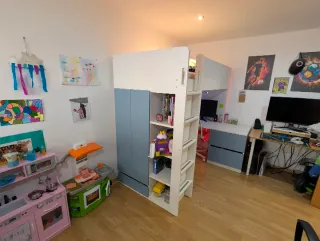 Cama alta con escritorio y estanterías Ikea.