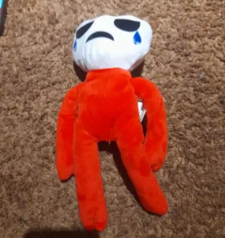 Peluche naranja con cara triste