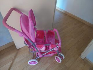 Cochecito gemelar para muñecas rosa