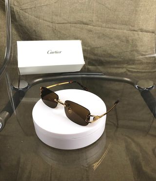 Gafas de sol Cartier doradas y marrones