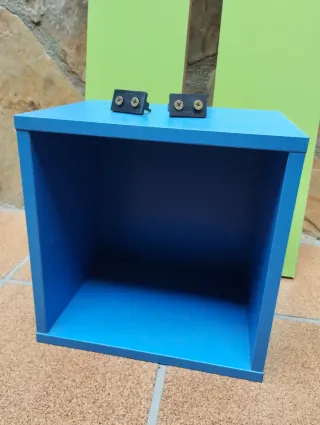 Estanterías verdes y cubo azul de madera