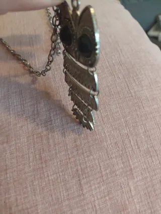 Colgante de buho plateado y negro.