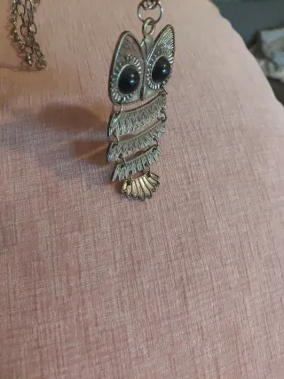 Colgante de buho plateado y negro.